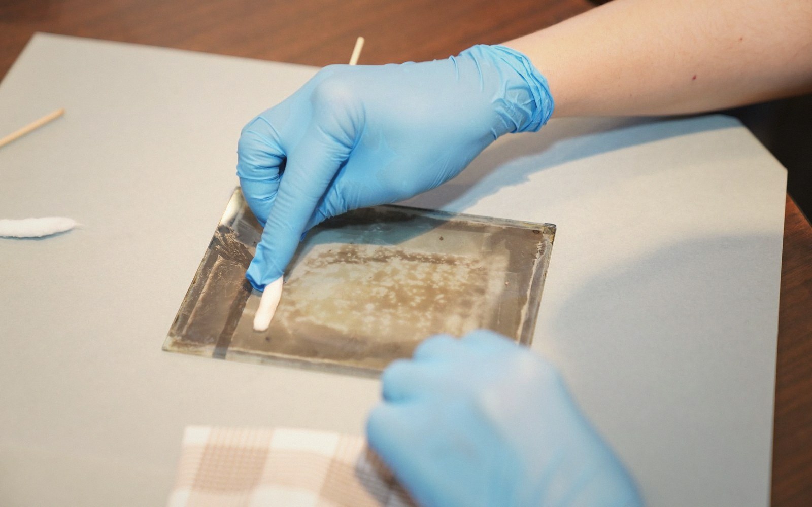 A clean rectangle opened in a yellowed varnish surface